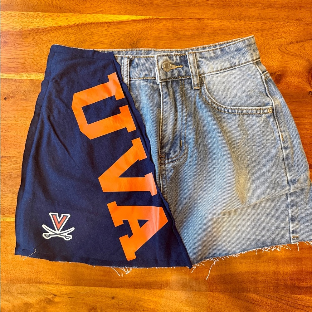 NEW. Size XS denim jean skirt w sewn-on UVA T-shirt patch.